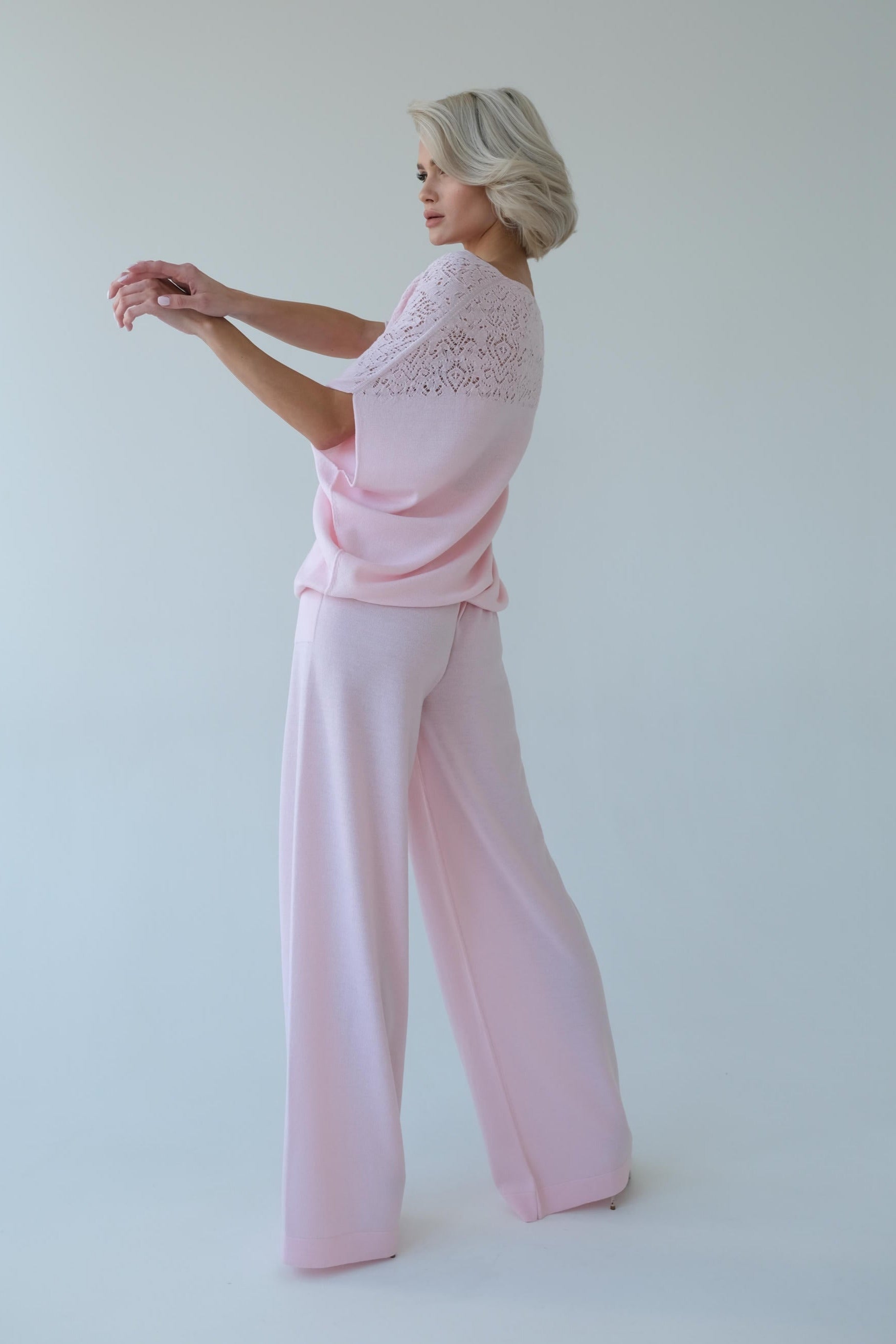 Woman wearing a pink outfit with a white background