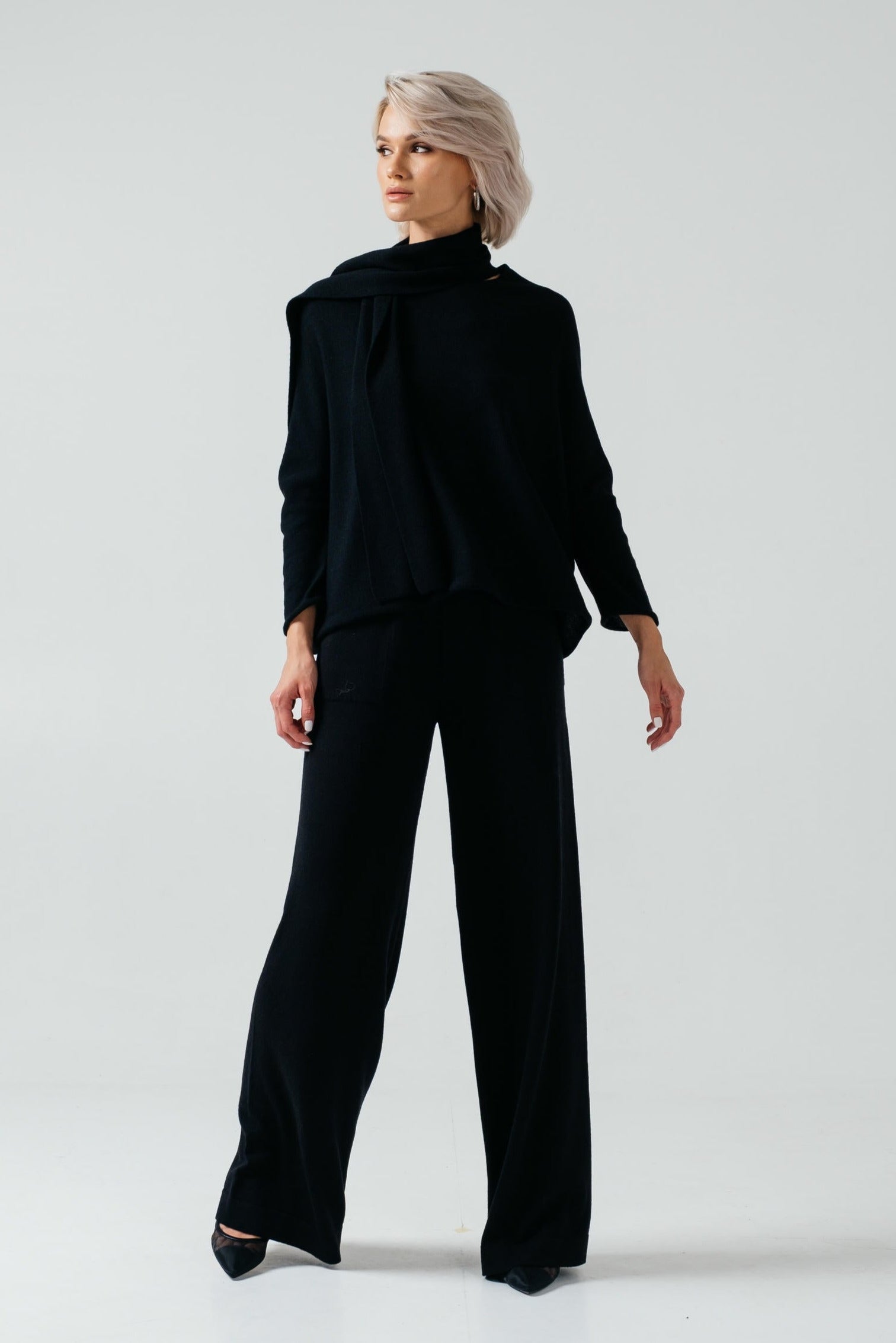 Woman wearing a black outfit on a white background