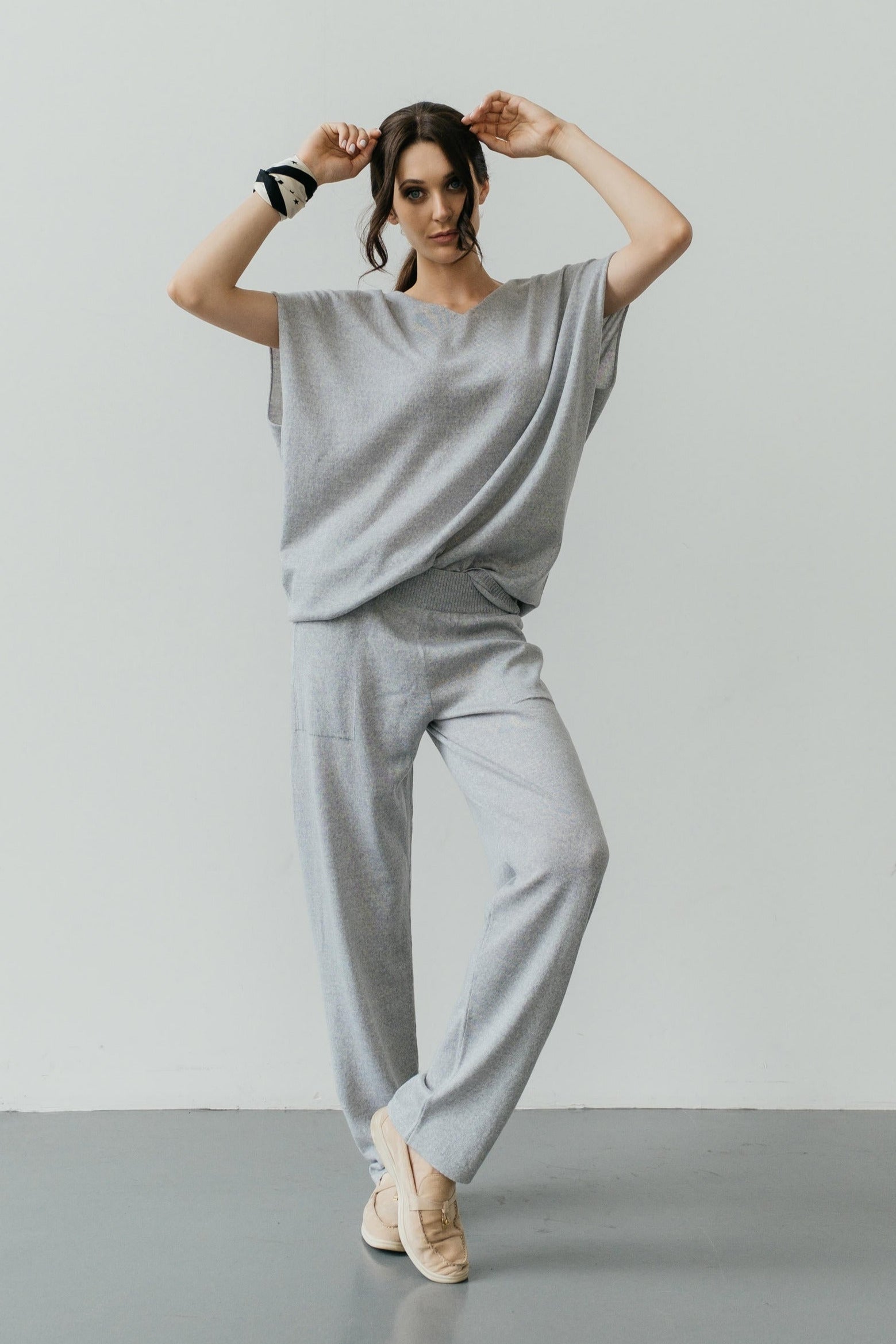 A pair of black, slim-fit, elastic waistband merino wool pants with no visible pockets.