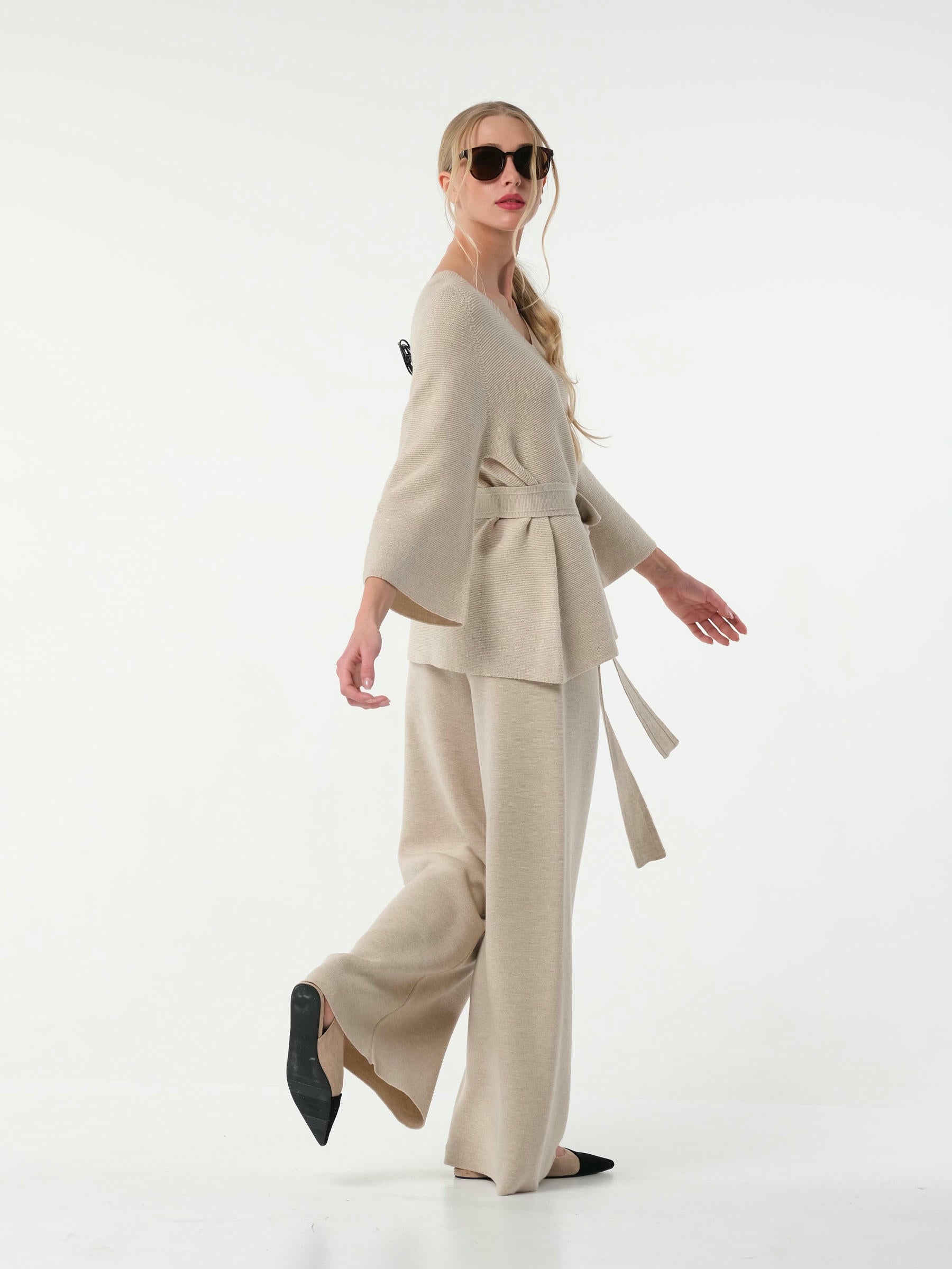 Woman wearing a beige suit on a white background