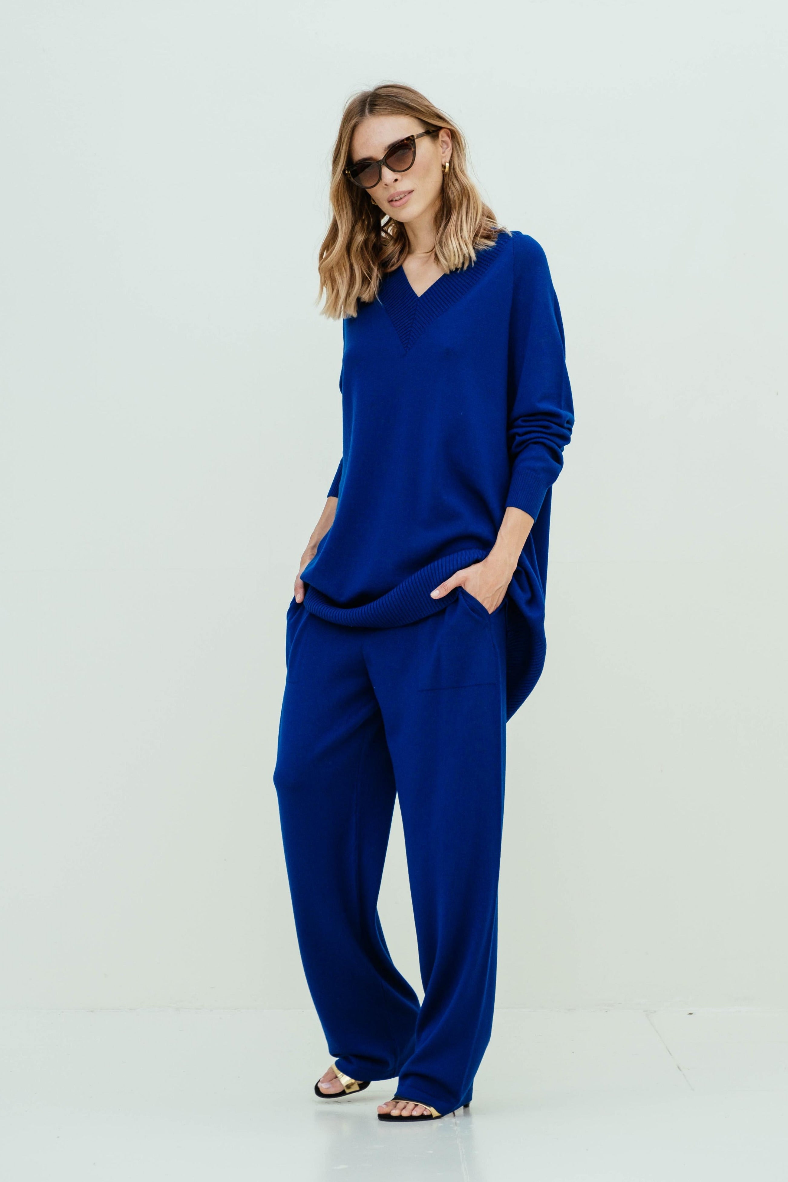 Woman wearing a blue outfit on a white background