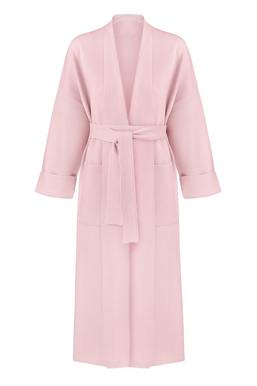 A pink merino wool coat with a belt, designed with wide sleeves and a V-neckline, displayed against a plain background.