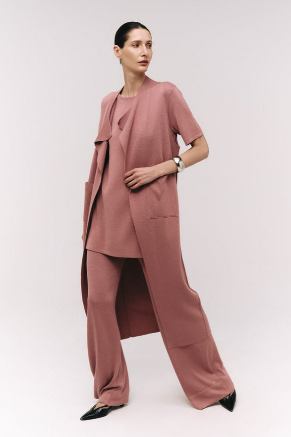 Woman wearing a pink outfit with a white background