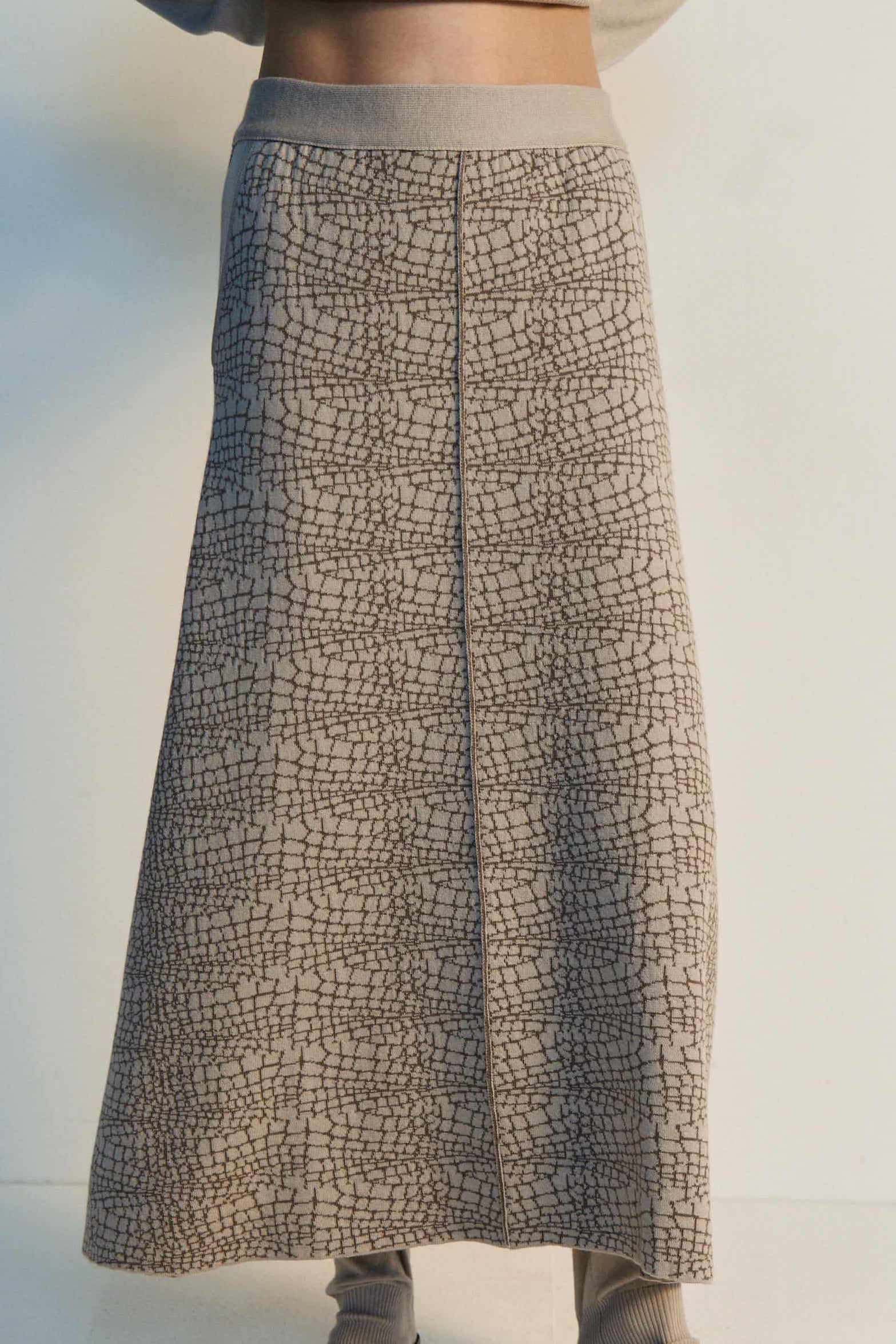 Long patterned skirt worn by a person on a white background