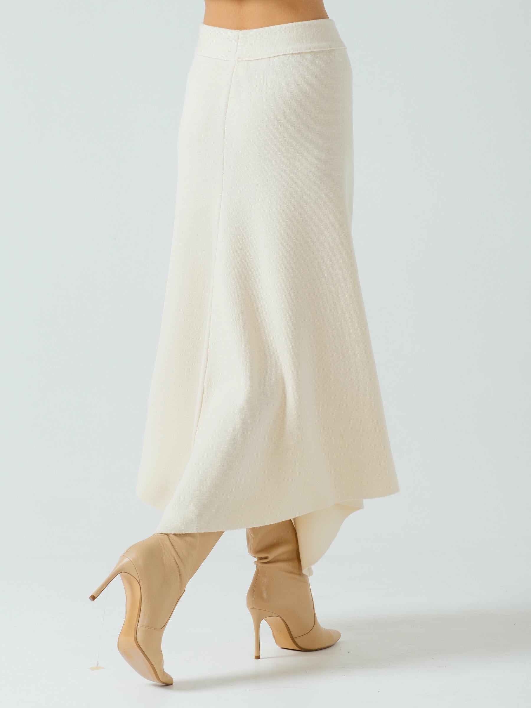 White skirt worn by a model on a plain background