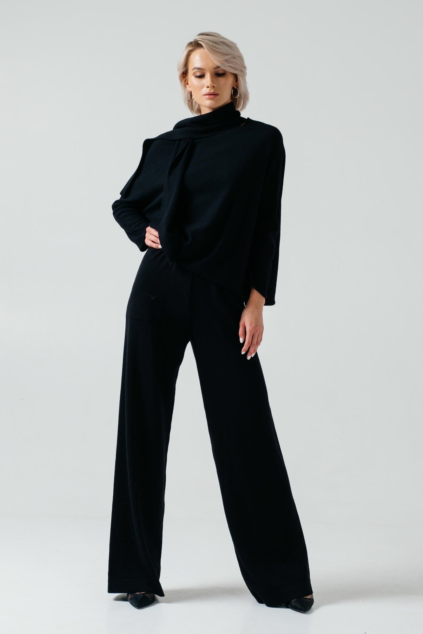 Woman wearing a black outfit on a white background