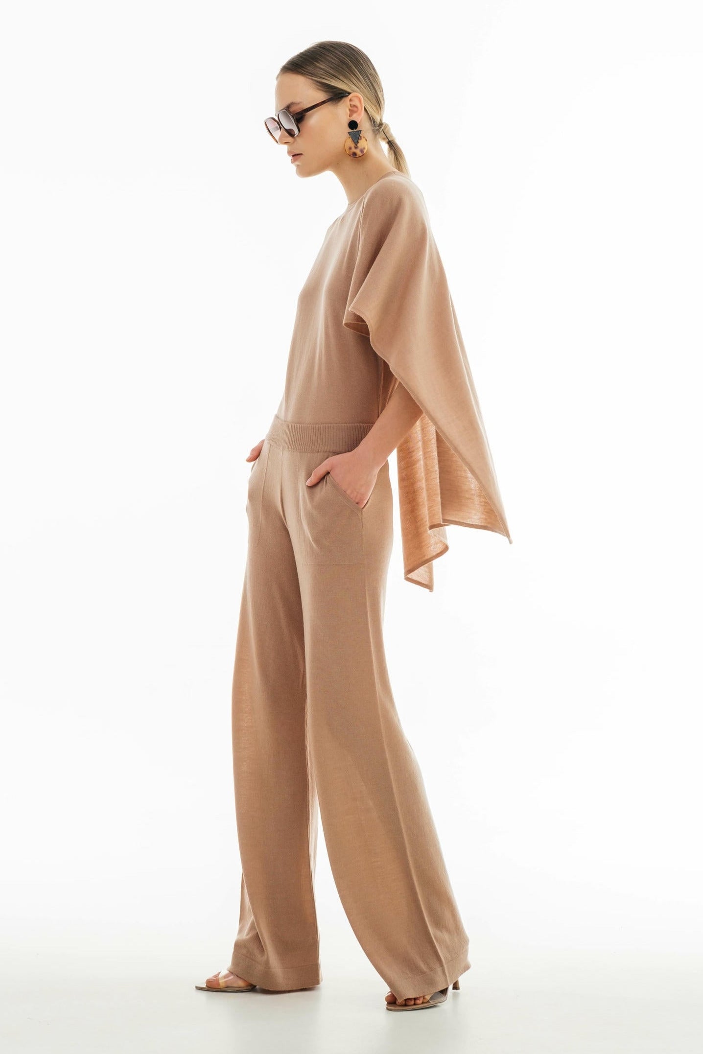 Woman wearing a beige outfit on a white background