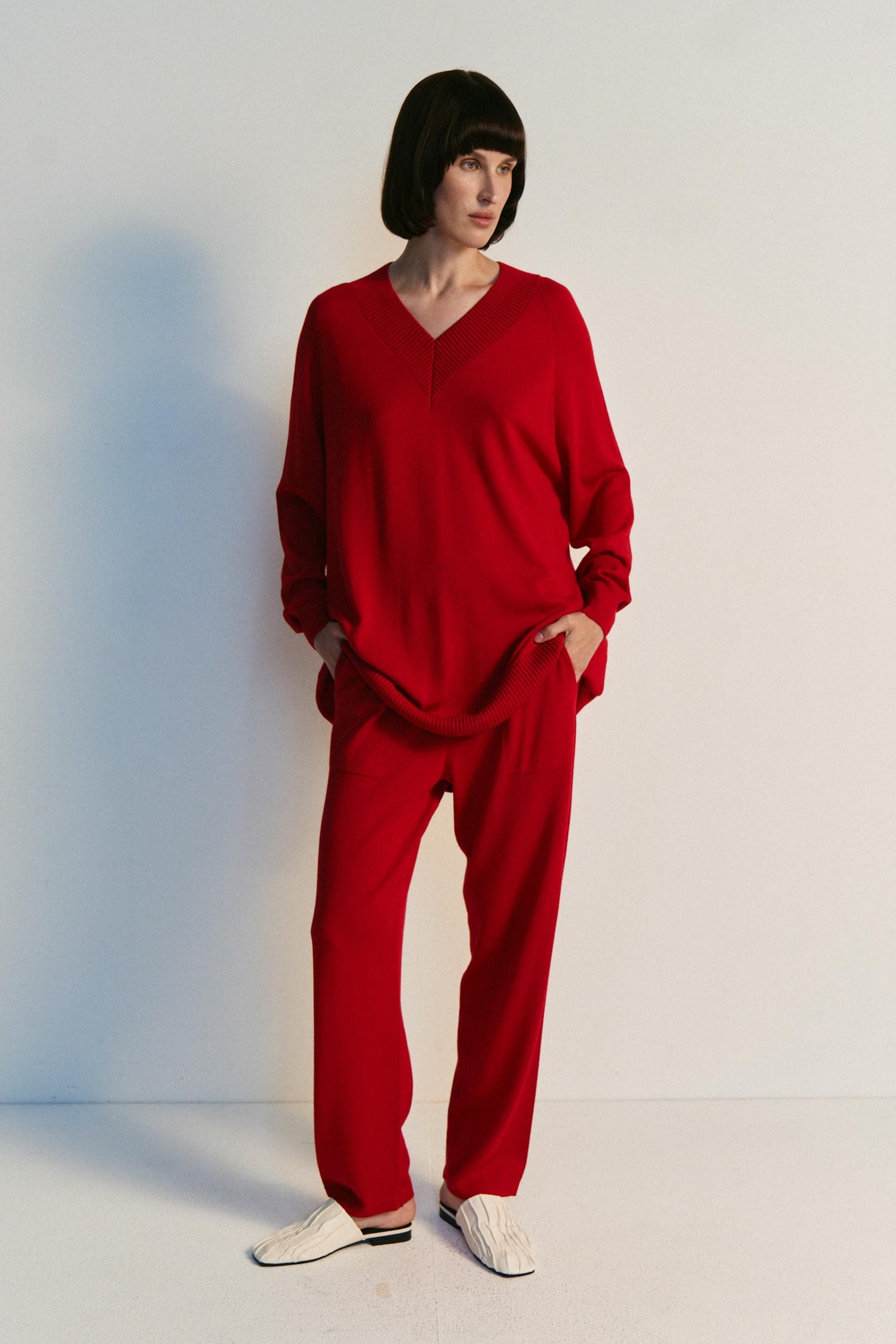 Person wearing a red outfit against a white background