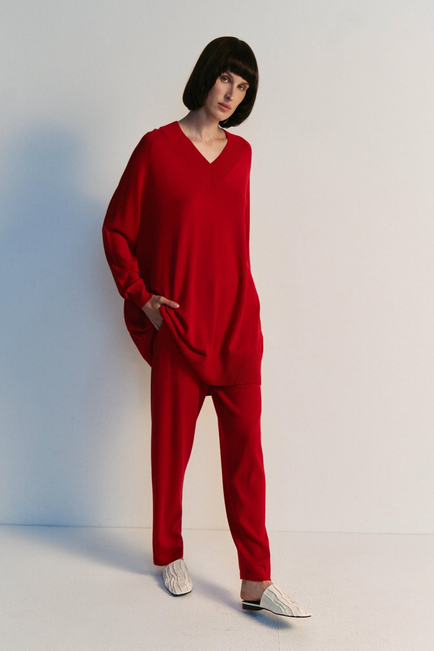 Person wearing a red outfit on a white background