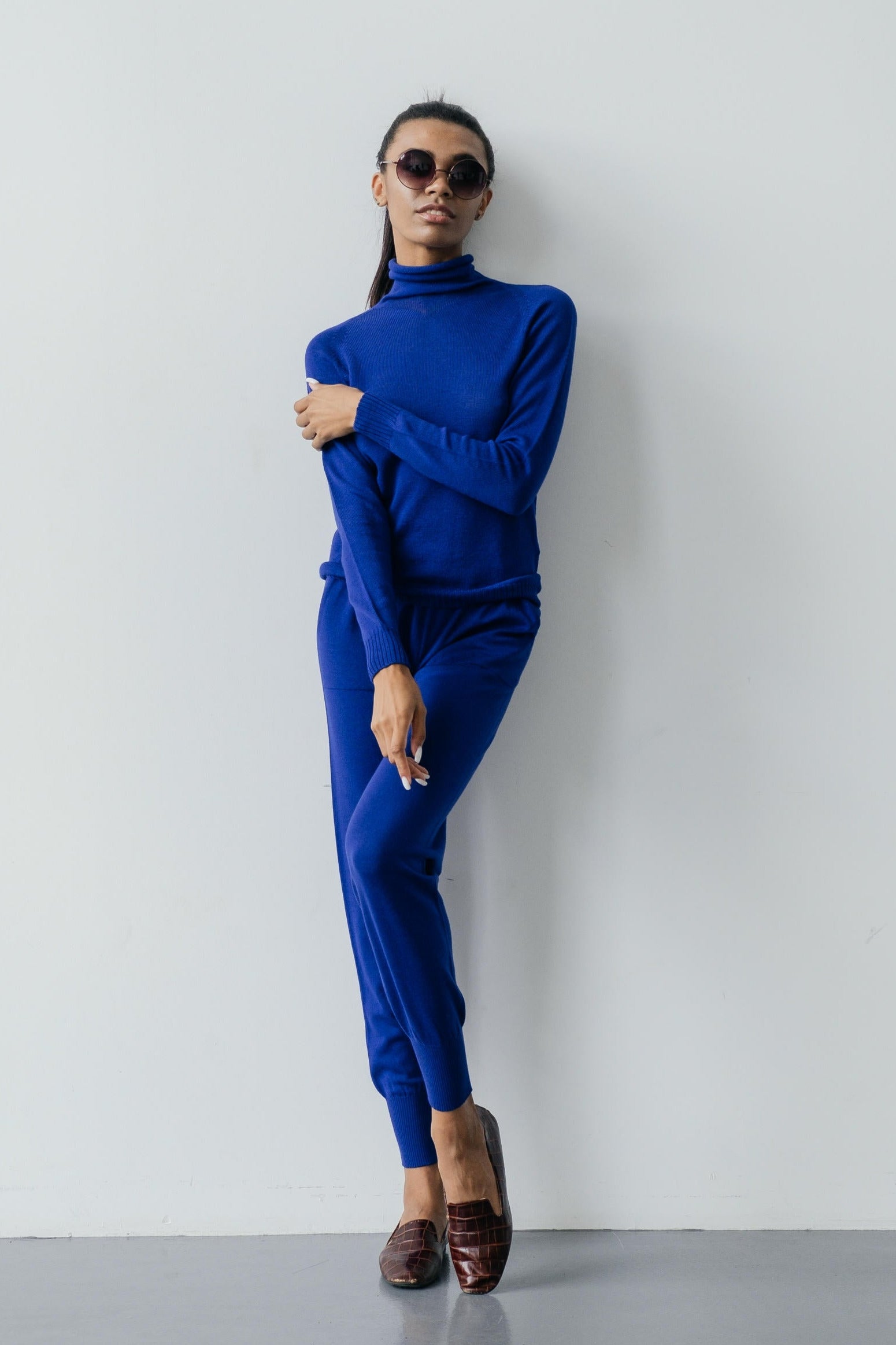 Person wearing a blue outfit against a white background